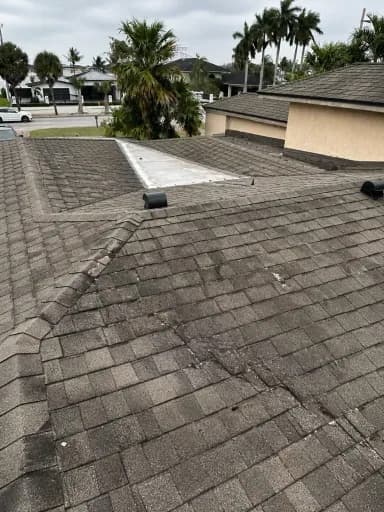 Roof before repair with visible wear and damage.